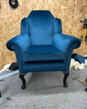 The same armchair reupholstered in blue velvet